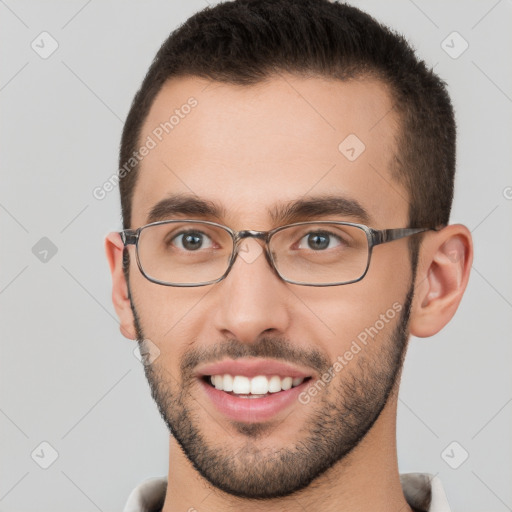 Joyful white young-adult male with short  brown hair and brown eyes