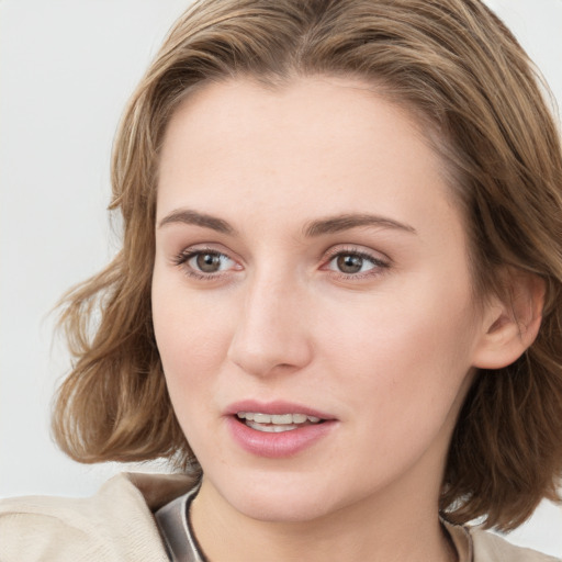 Joyful white young-adult female with medium  brown hair and blue eyes