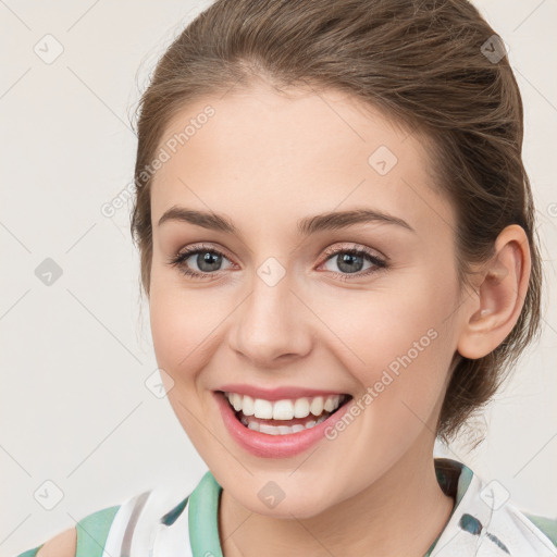 Joyful white young-adult female with medium  brown hair and green eyes