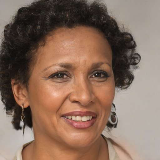 Joyful black adult female with medium  brown hair and brown eyes