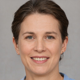 Joyful white adult female with short  brown hair and grey eyes