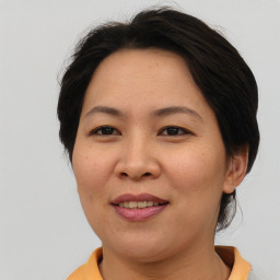 Joyful asian adult female with short  brown hair and brown eyes