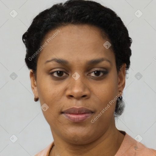 Joyful black young-adult female with short  black hair and brown eyes