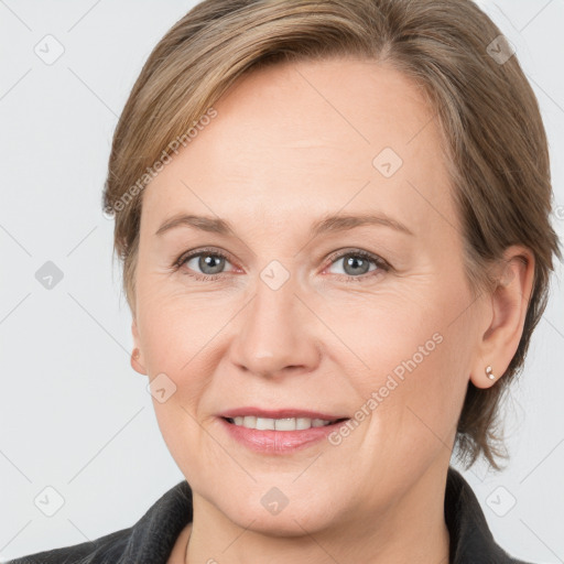 Joyful white adult female with medium  brown hair and grey eyes