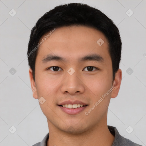 Joyful asian young-adult male with short  black hair and brown eyes