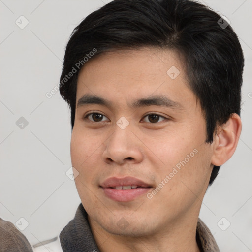Joyful asian young-adult male with short  black hair and brown eyes