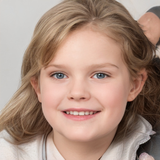 Joyful white child female with medium  brown hair and blue eyes