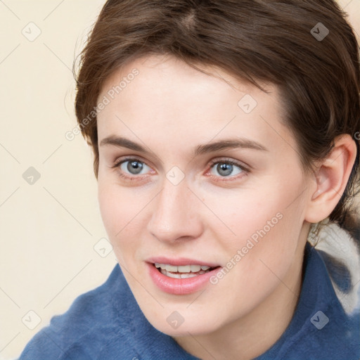 Joyful white young-adult female with medium  brown hair and blue eyes