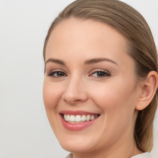 Joyful white young-adult female with long  brown hair and grey eyes