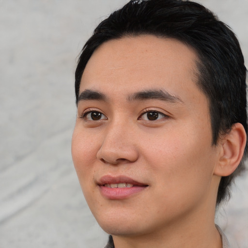 Joyful asian young-adult male with short  black hair and brown eyes