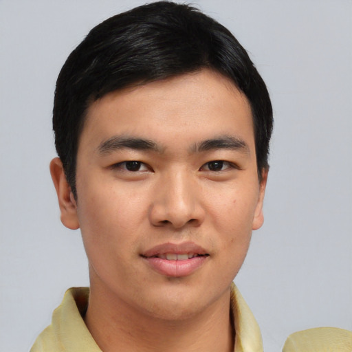 Joyful asian young-adult male with short  black hair and brown eyes