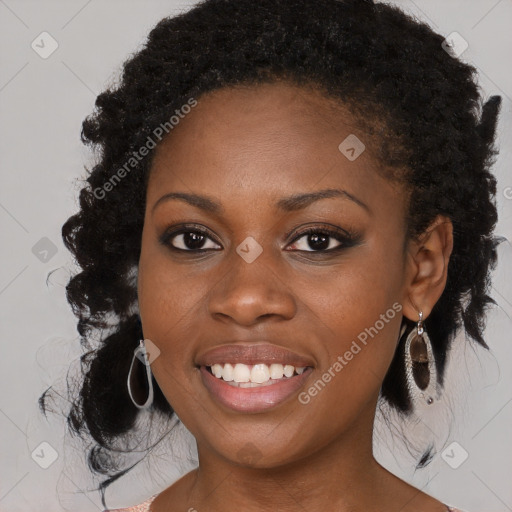 Joyful black young-adult female with long  black hair and brown eyes