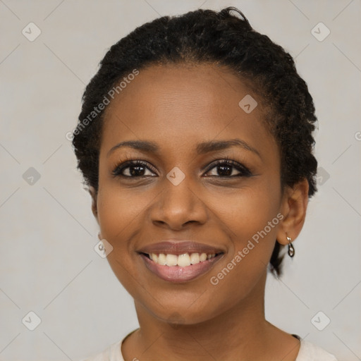 Joyful black young-adult female with short  black hair and brown eyes