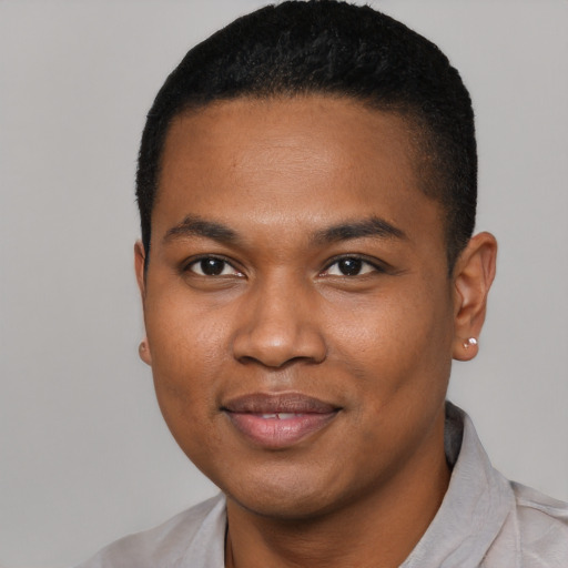 Joyful black young-adult male with short  black hair and brown eyes
