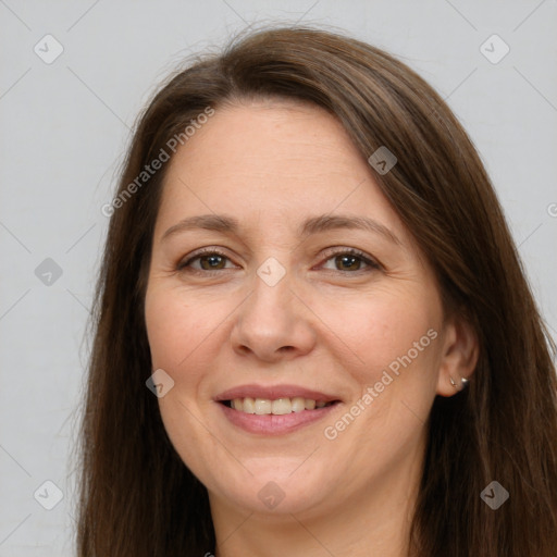 Joyful white adult female with long  brown hair and brown eyes