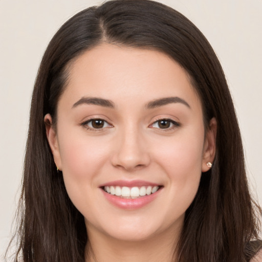 Joyful white young-adult female with long  brown hair and brown eyes