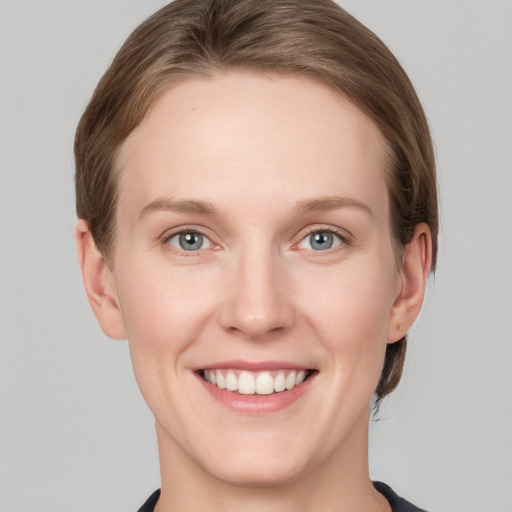 Joyful white young-adult female with short  brown hair and grey eyes