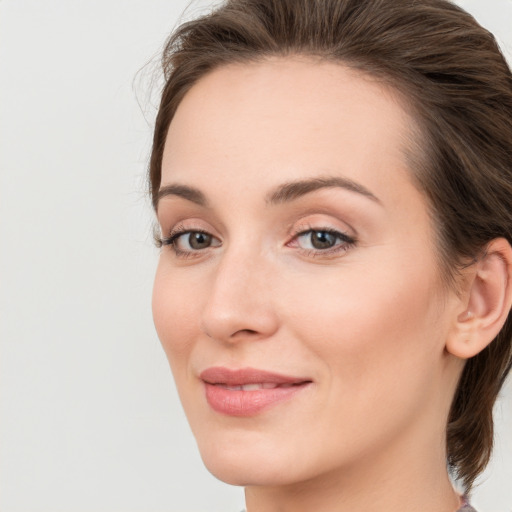 Joyful white young-adult female with medium  brown hair and blue eyes