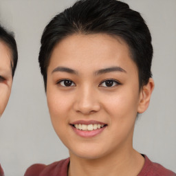 Joyful asian young-adult female with short  brown hair and brown eyes