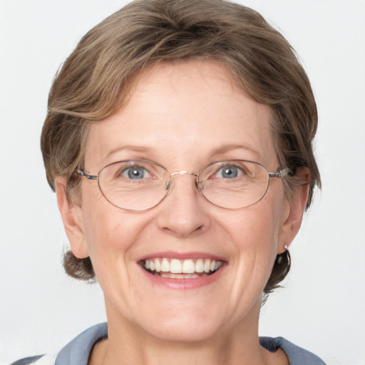 Joyful white adult female with medium  brown hair and blue eyes