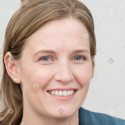 Joyful white young-adult female with long  brown hair and blue eyes