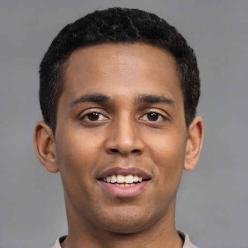 Joyful latino young-adult male with short  brown hair and brown eyes