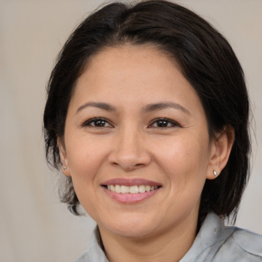 Joyful white adult female with medium  brown hair and brown eyes
