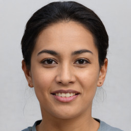 Joyful latino young-adult female with short  brown hair and brown eyes