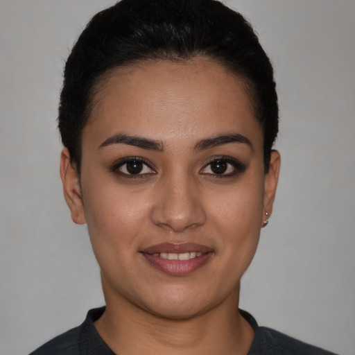 Joyful white young-adult female with short  black hair and brown eyes