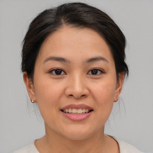 Joyful asian young-adult female with medium  brown hair and brown eyes