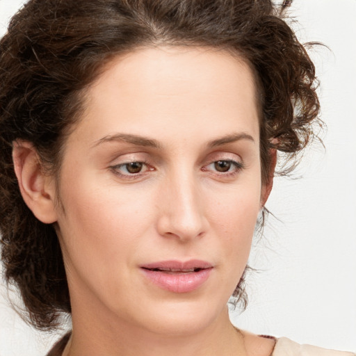 Joyful white young-adult female with medium  brown hair and green eyes