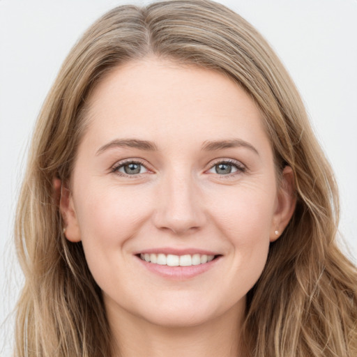 Joyful white young-adult female with long  brown hair and blue eyes