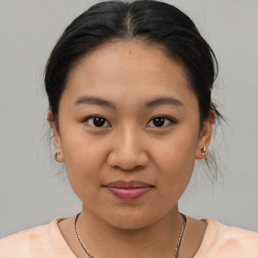 Joyful latino young-adult female with medium  brown hair and brown eyes