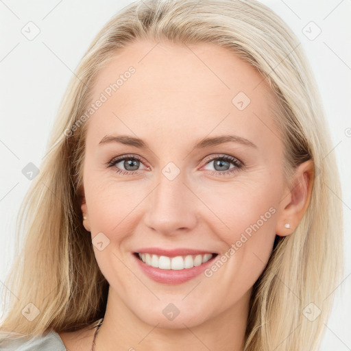 Joyful white young-adult female with long  brown hair and blue eyes