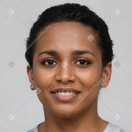 Joyful black young-adult female with short  brown hair and brown eyes