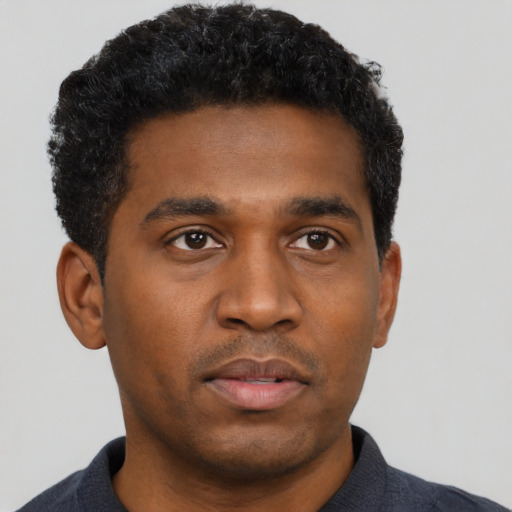 Neutral black young-adult male with short  black hair and brown eyes