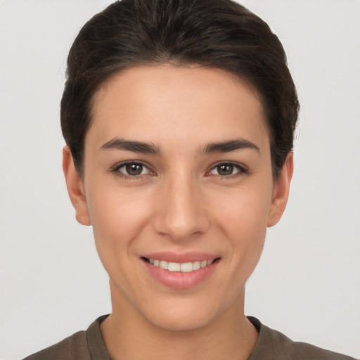 Joyful white young-adult female with short  brown hair and brown eyes