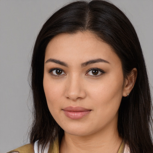 Joyful latino young-adult female with long  brown hair and brown eyes