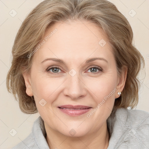 Joyful white adult female with medium  brown hair and grey eyes