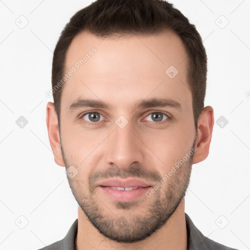 Joyful white young-adult male with short  brown hair and grey eyes