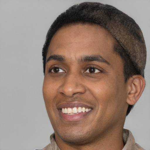 Joyful latino young-adult male with short  black hair and brown eyes
