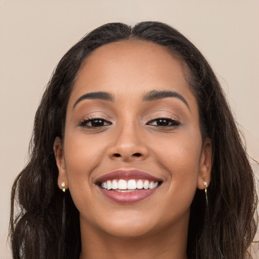 Joyful white young-adult female with long  brown hair and brown eyes