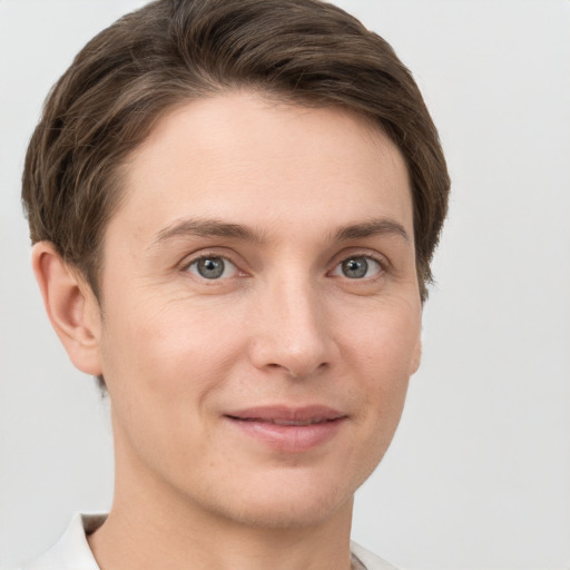 Joyful white young-adult female with short  brown hair and grey eyes