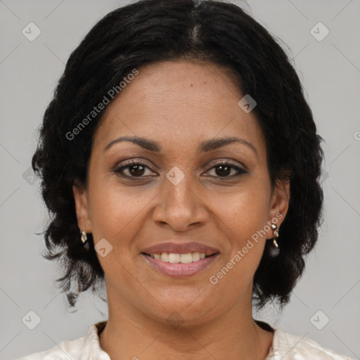 Joyful black adult female with medium  brown hair and brown eyes