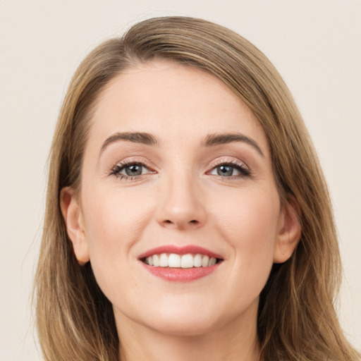 Joyful white young-adult female with long  brown hair and grey eyes