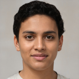 Joyful latino young-adult male with short  brown hair and brown eyes