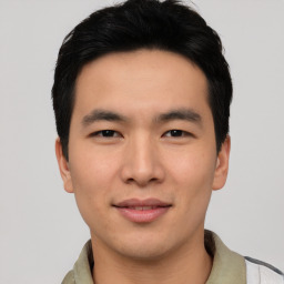 Joyful asian young-adult male with short  black hair and brown eyes