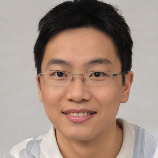 Joyful asian young-adult male with short  black hair and brown eyes