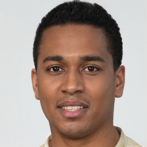 Joyful black young-adult male with short  black hair and brown eyes