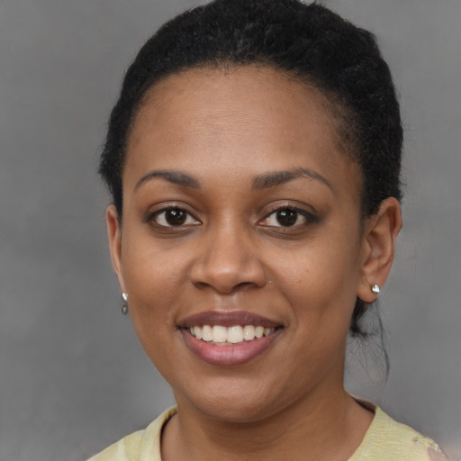 Joyful black young-adult female with short  brown hair and brown eyes